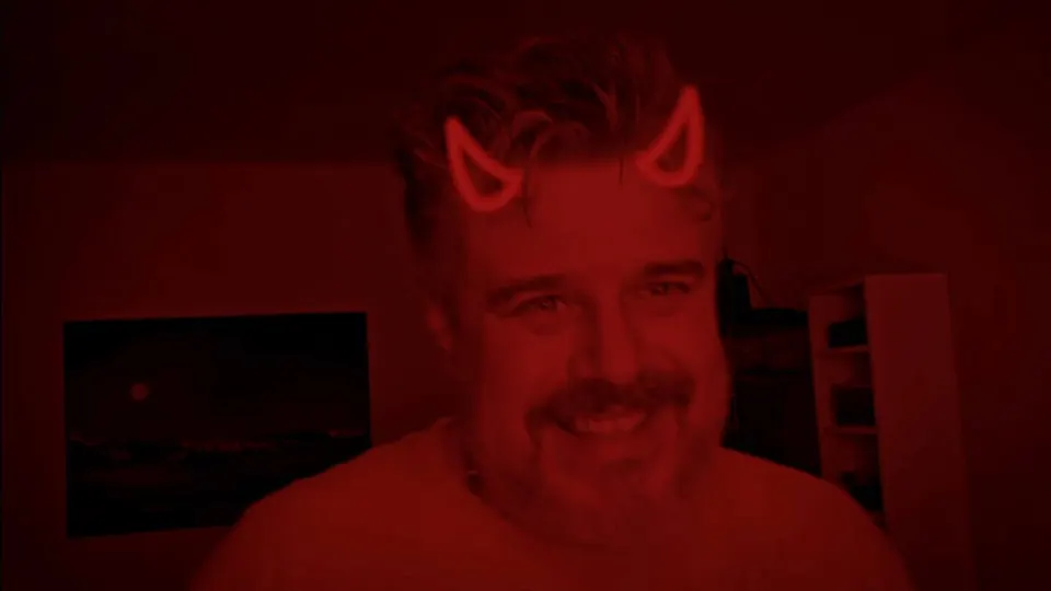 Still from “Vertrag für dich”: Marko in red light wearing devil horns